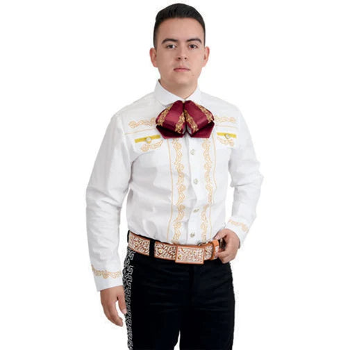 A man wearing a traditional white Charro shirt with gold embroidery and unique buttons, paired with a red bow tie and black pants.