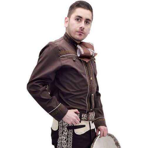 A man wearing a brown Charro shirt with traditional embroidery on the front, back, and sleeves. The shirt features unique buttons and a design that includes horse shoe and Greco details.