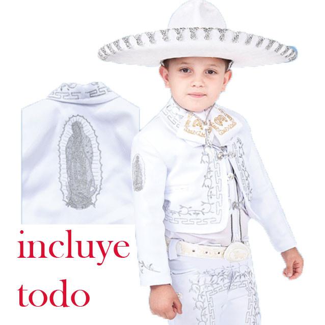 A young boy wearing a traditional charro suit with detailed embroidery and a sombrero, including a white shirt and a decorative belt.