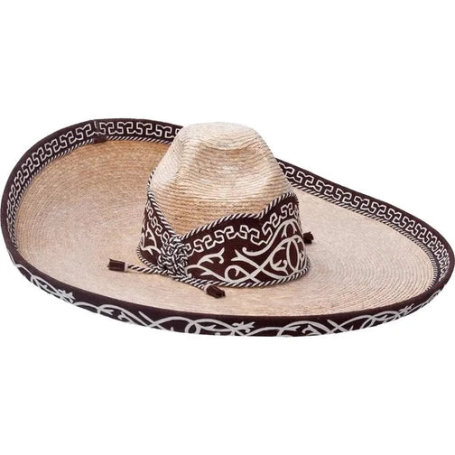 A traditional Mexican sombrero with a white brim and brown crown, featuring a black and white geometric pattern around the crown and a decorative band.