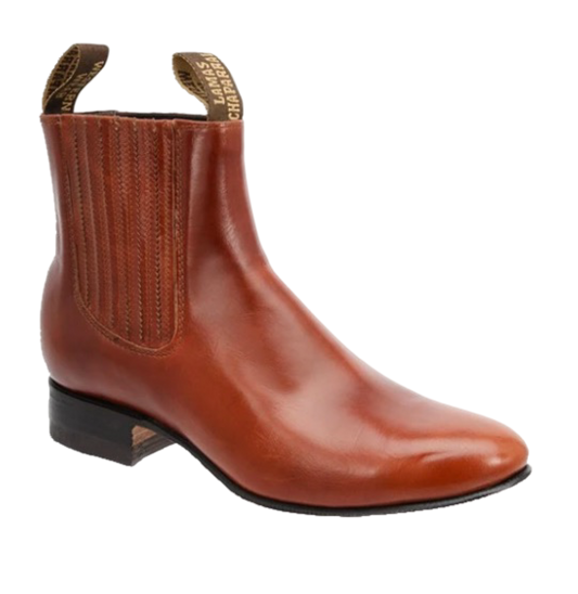 A brown leather ankle boot with a round toe and a traditional low heel, handcrafted on a last.