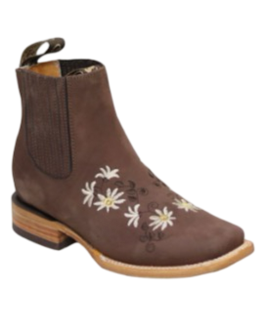 A brown woman's boot with white floral embroidery on the top and a square toe style.