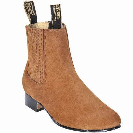 Tan ankle boot with black sole on a white background