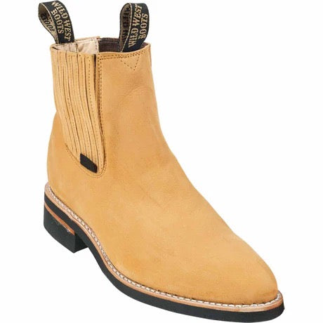 Tan leather boot with black sole on a white background