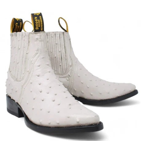 White cowboy boots with black soles on a white background