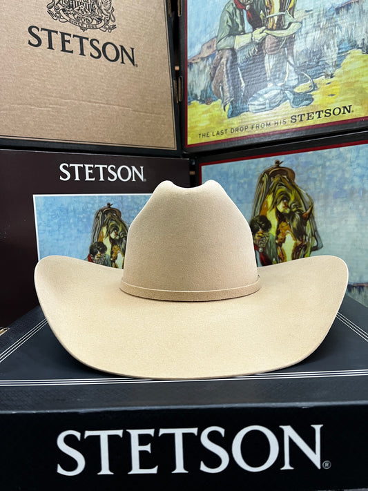Beige Stetson hat displayed in front of a Stetson branded box with promotional images.