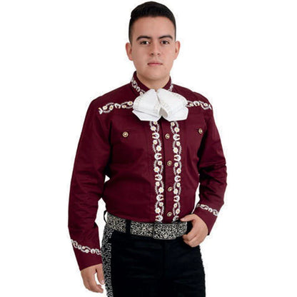 A man wearing a traditional Charro shirt with embroidery on the front, back, and sleeves. The shirt is primarily red with white embroidery, and the person is also wearing a white bow tie and black pants.