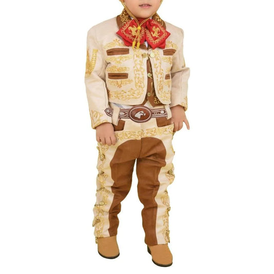 A young boy wearing a traditional charro outfit with a multicolored floral shirt, beige jacket, brown pants, and a sombrero.