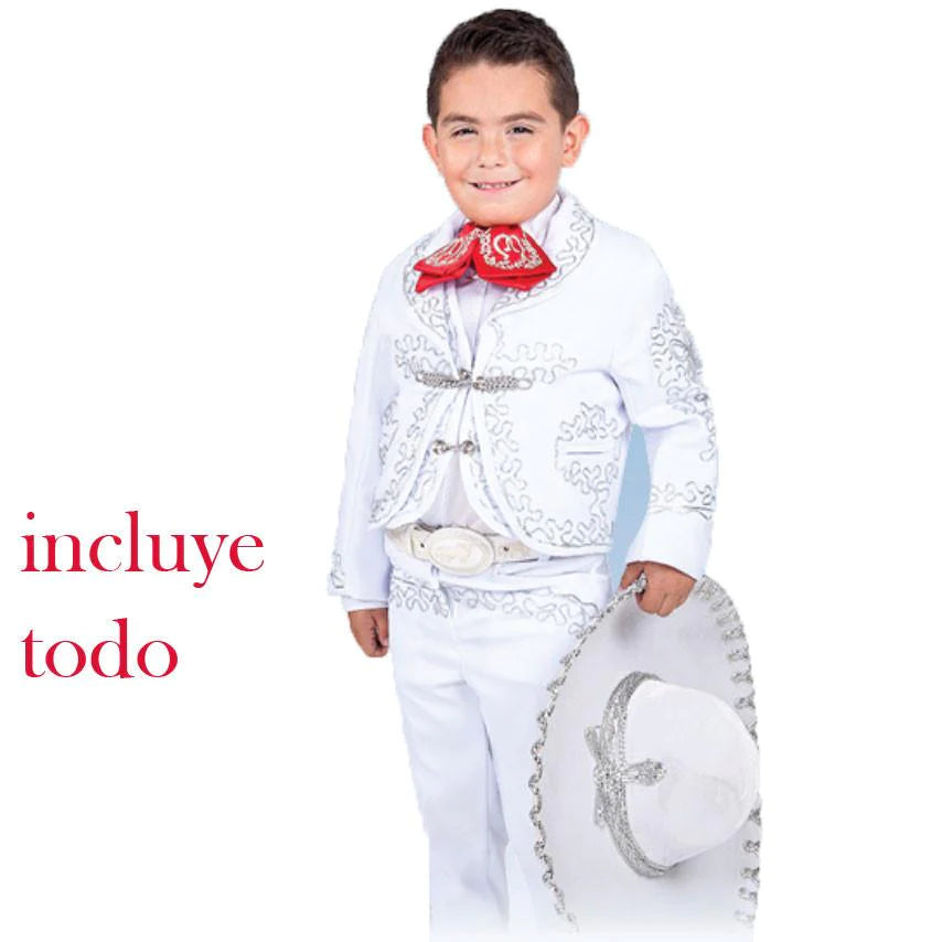 A young boy wearing a traditional white charro suit with embroidery and button details, including a sombrero and belt.