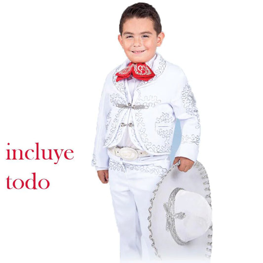 A young boy wearing a traditional white charro suit with embroidery and button details, including a sombrero and belt.
