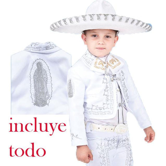 A young boy wearing a traditional charro suit with detailed embroidery and a sombrero, including a white shirt and a decorative belt.