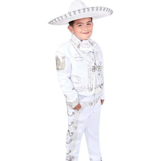 A young boy wearing a traditional white charro suit with embroidery and a sombrero.