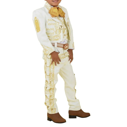 A young boy wearing a traditional charro suit with white pants and a white shirt, featuring gold embroidery, a sombrero, and belt.