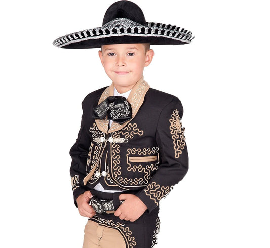 A young boy wearing a traditional charro suit with black and gold embroidery, including a sombrero with a black bandolero.