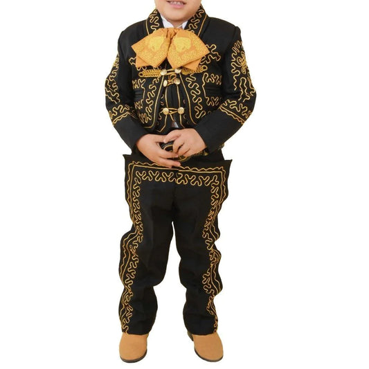 A young boy wearing a traditional charro suit with black and gold colors, including a jacket, pants, a vest, shirt, bow tie, and a sombrero.