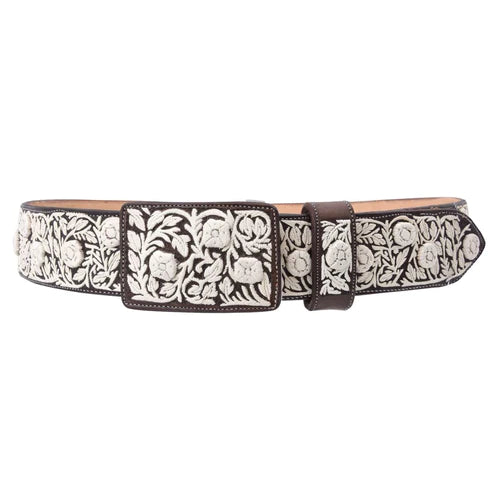 A traditional Mexican embroidered belt with floral patterns and a metallic buckle, primarily in black and white.