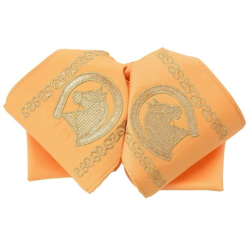 A traditional Mexican charro bow tie in a peach color with gold embroidery depicting a horse and rider.