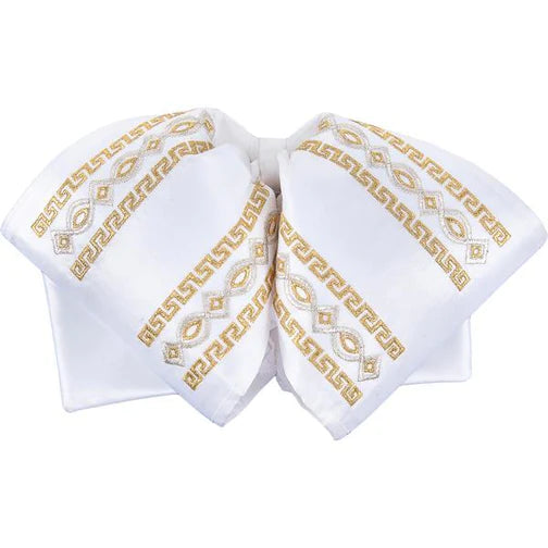 A traditional Mexican charro bow with white satin fabric and gold embroidered geometric patterns.