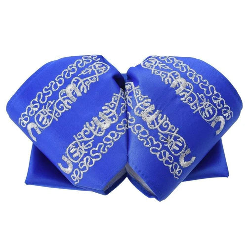 A traditional blue charro bow tie with white diamond pattern embroidery.
