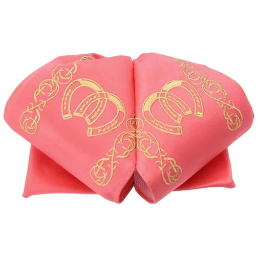 A traditional Mexican charro hat with white and gold embroidery on a pink base.