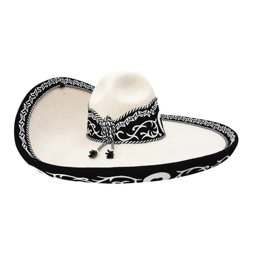 A traditional Mexican Sombrero Charro with a white brim and black diamond pattern, featuring a decorative band and a small feather.