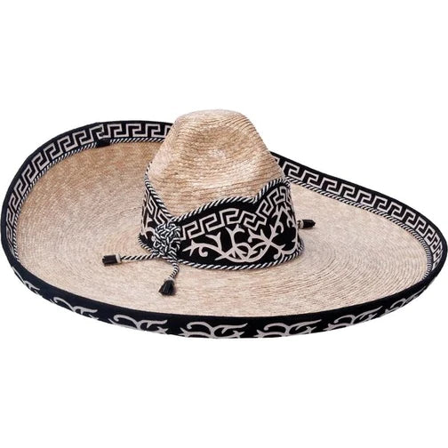 A traditional Mexican sombrero with a white brim and black geometric pattern, featuring a black and white decorative band and tassels.