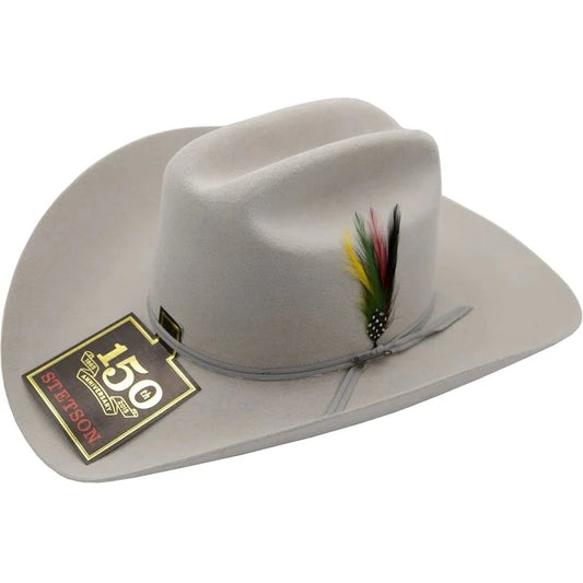 A silvergray Stetson cowboy hat with a feather decoration on the side, displayed with its tag showing the model name and brand.